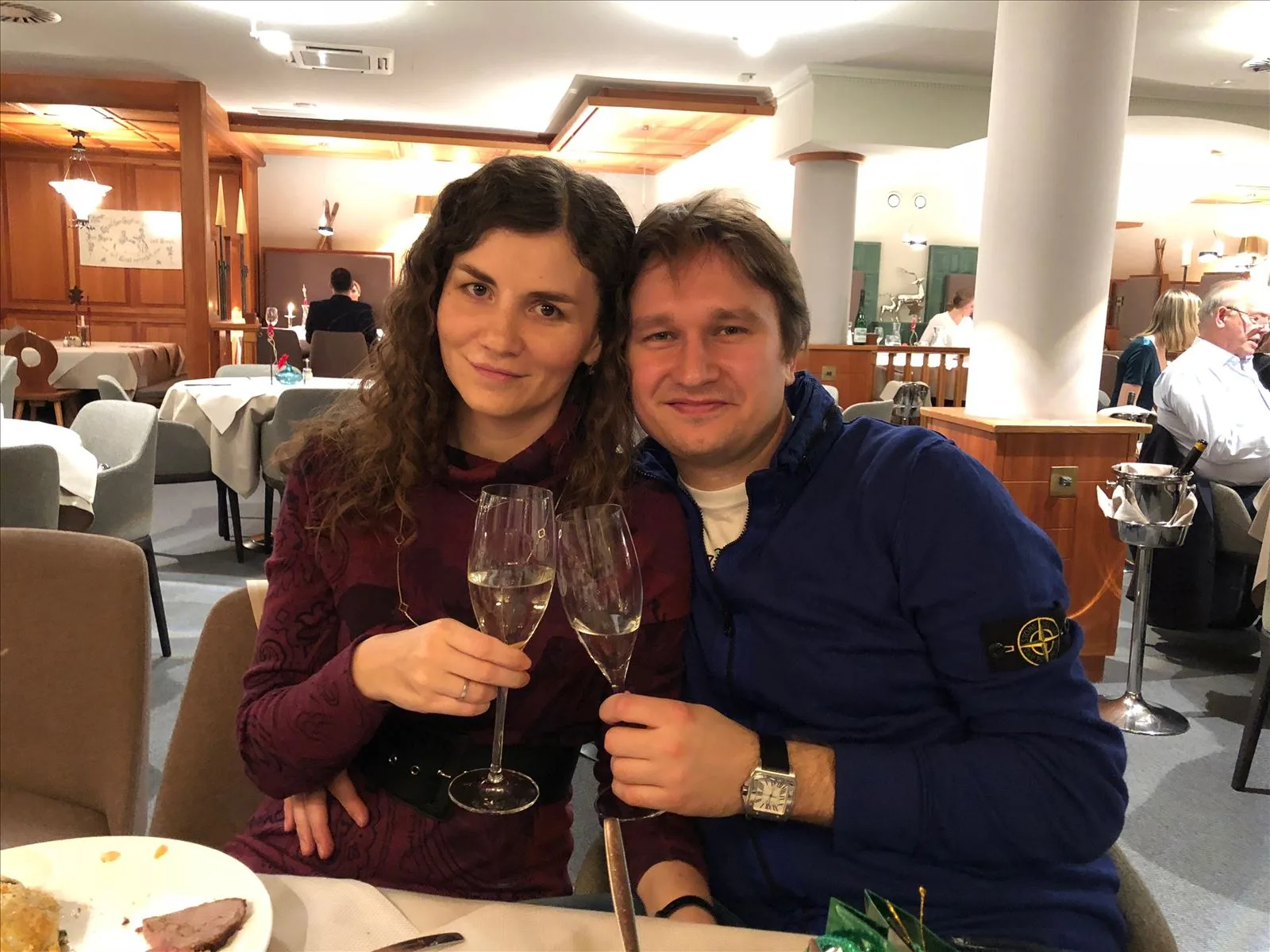 Couple with champagne glasses in an Austrian restaurant