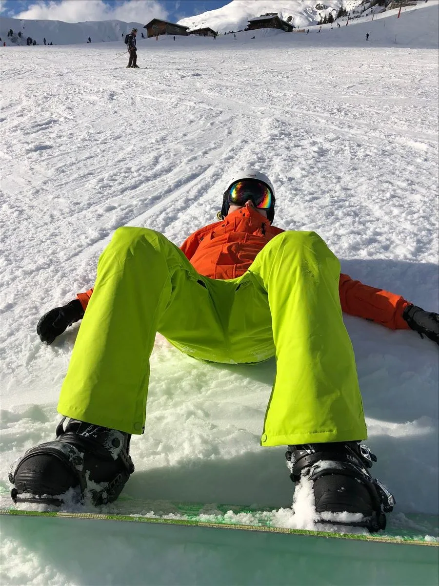 Skier in green pants on snow