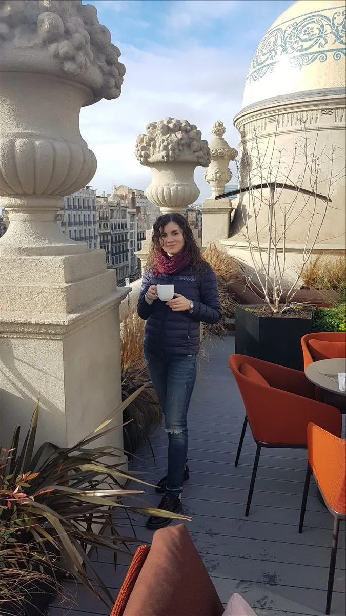 Girl with coffee against Gothic Quarter