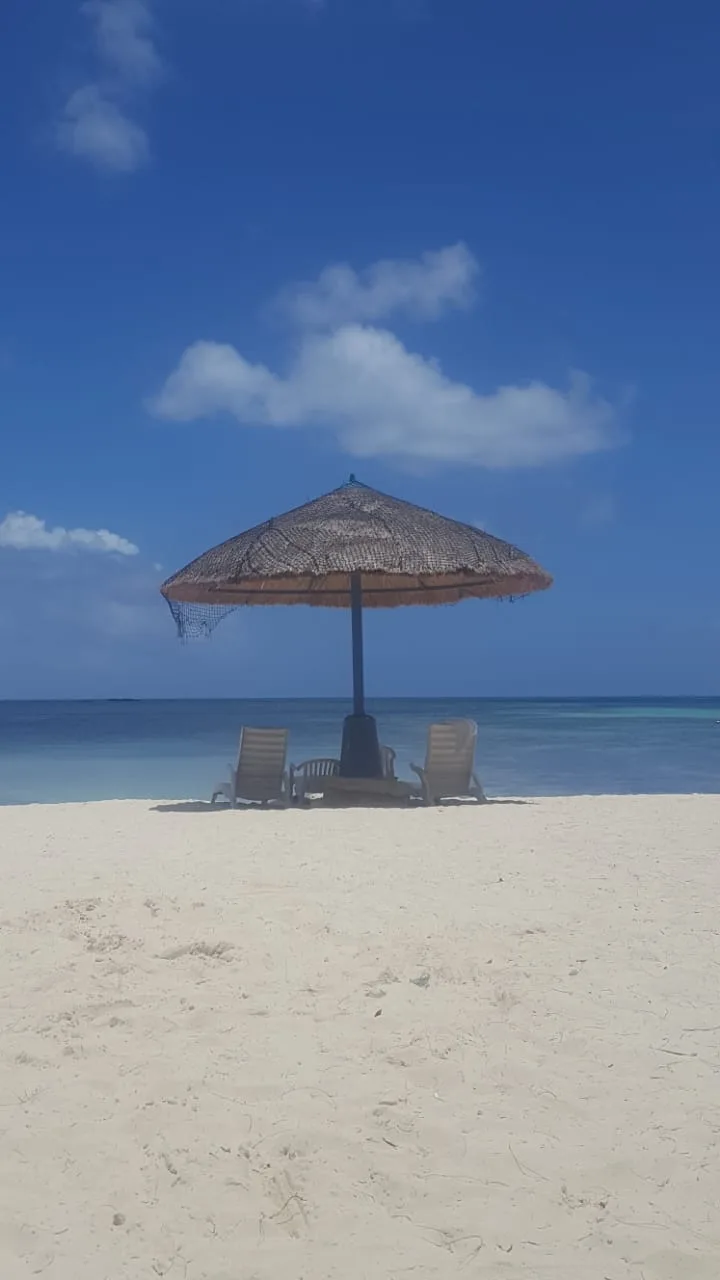 Sun umbrella and loungers by the sea, Saipan