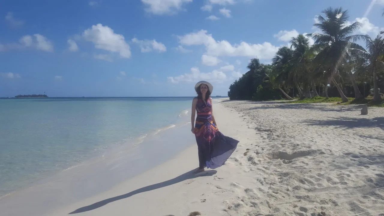 Girl in a dress on the white beach of Saipan