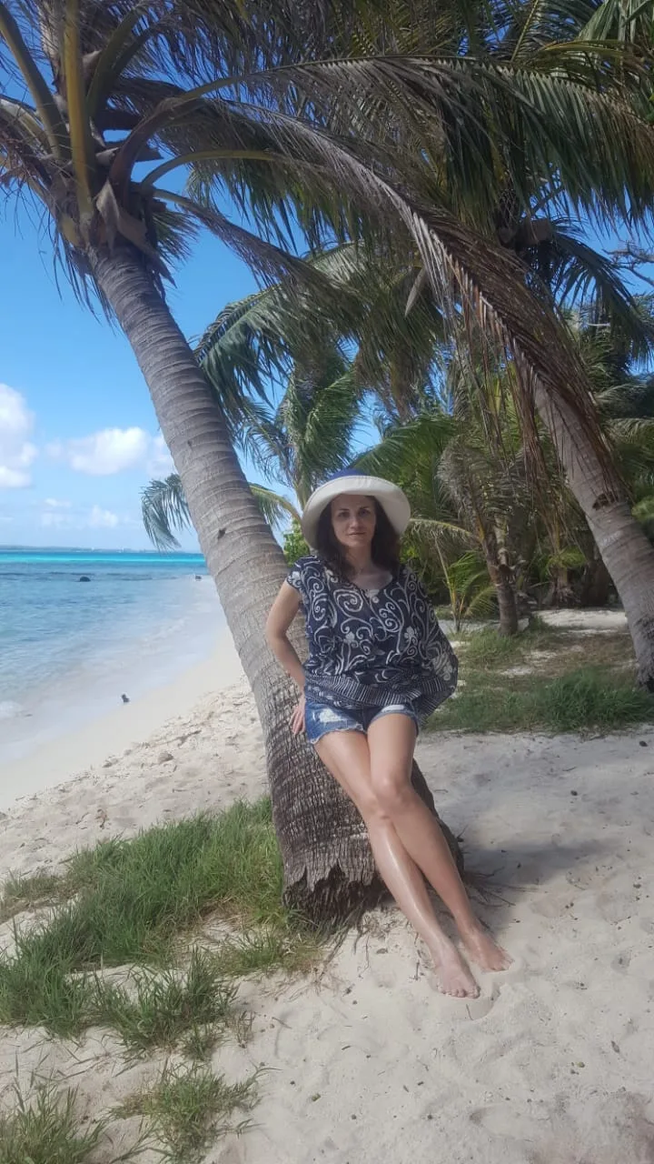 Girl by a palm tree on Saipan beach