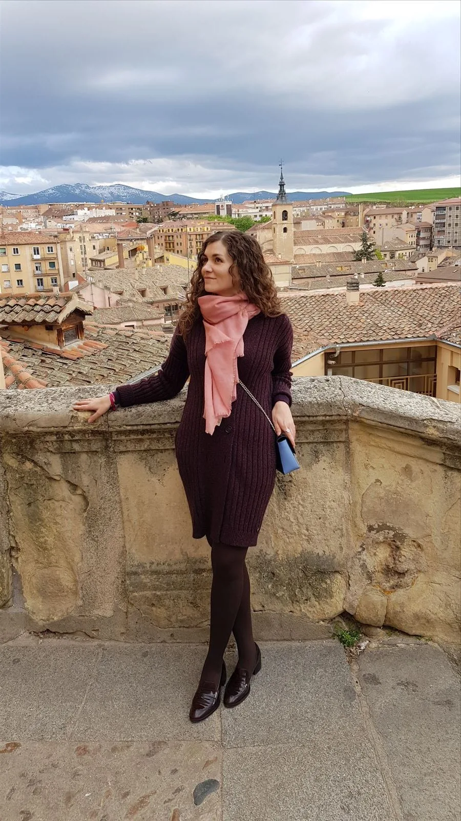 Tourist with Segovia streets in the background