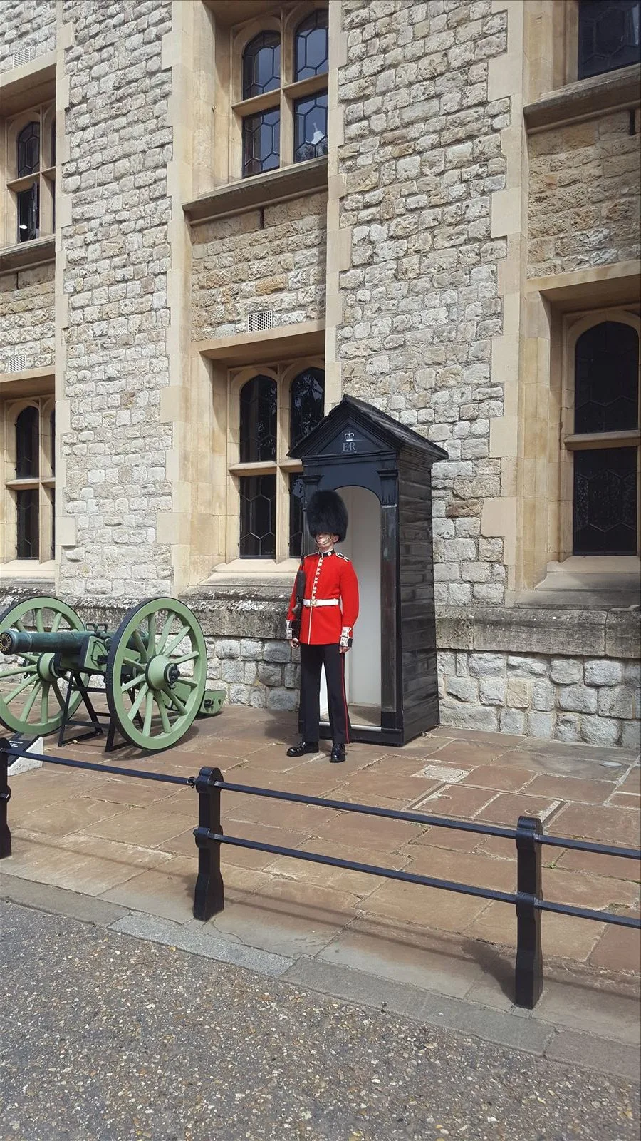 Girl by a cannon in front of the Tower of London
