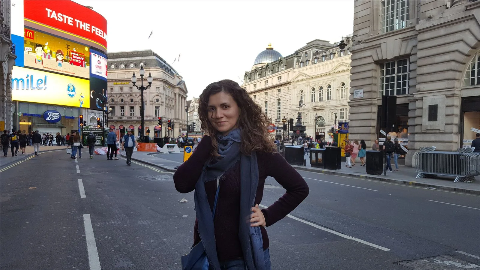 Girl on the streets of London with a red bus