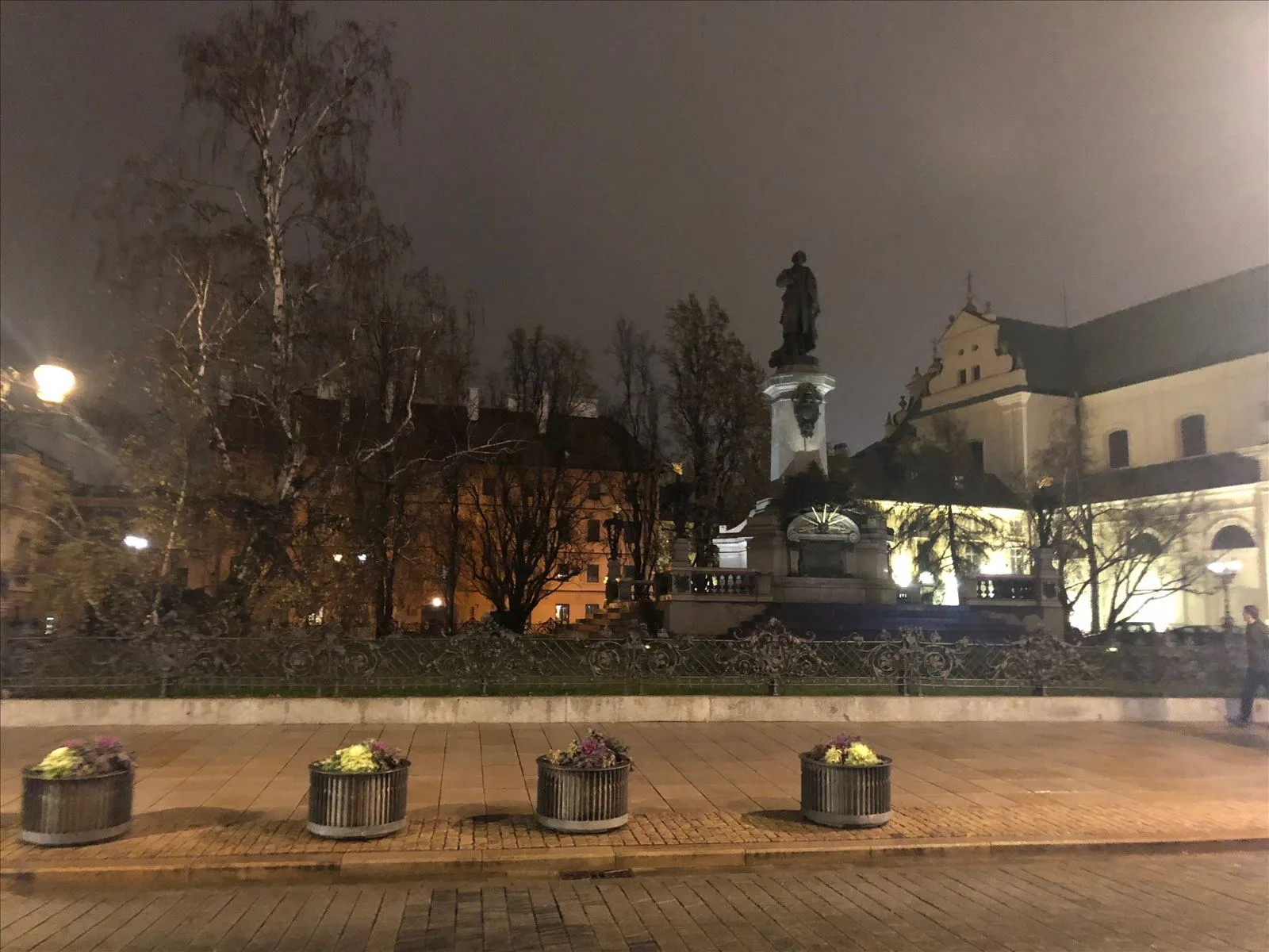 Square with monument on winter evening, Warsaw