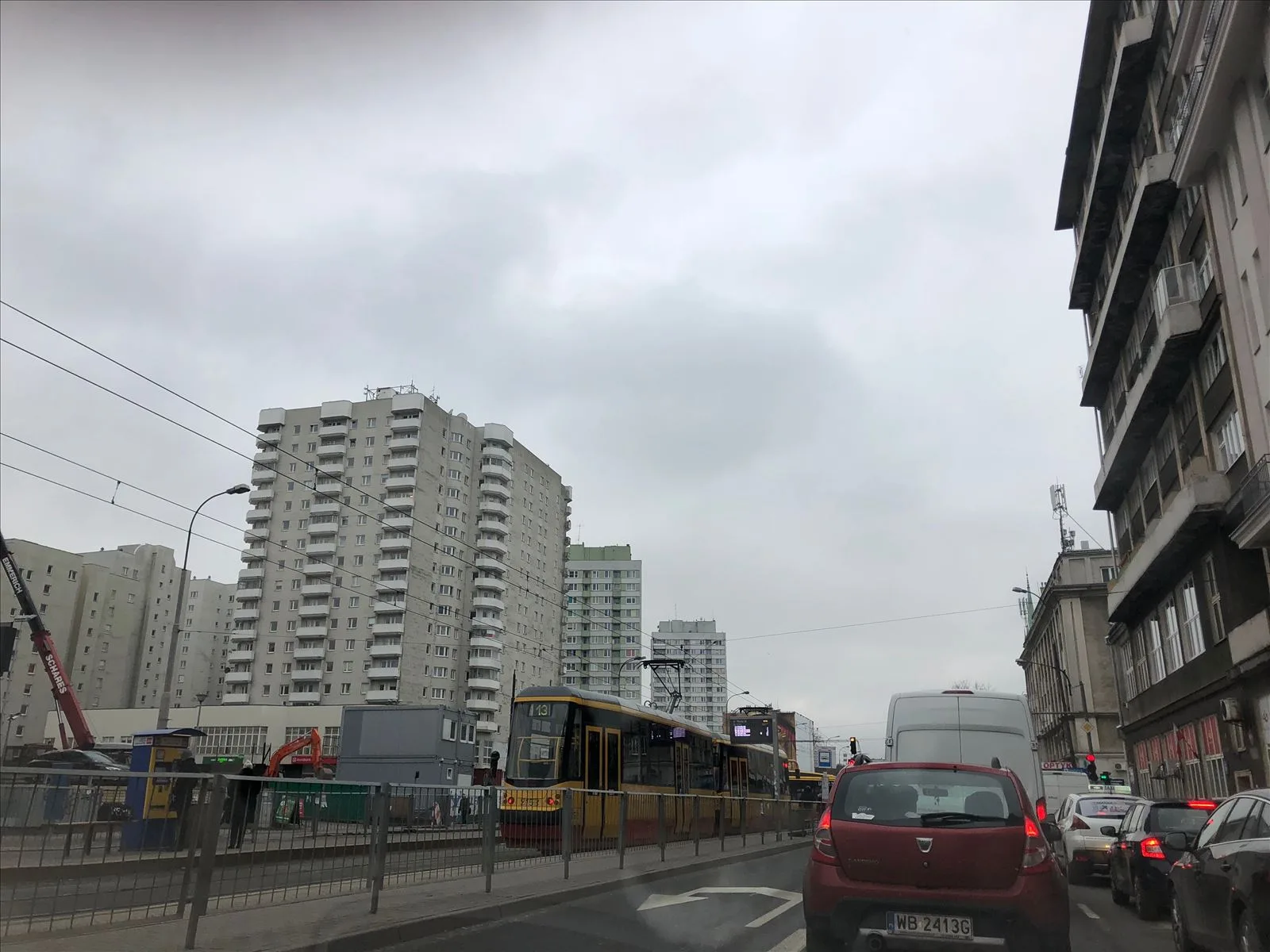 Wide avenue in Warsaw with cars during the day