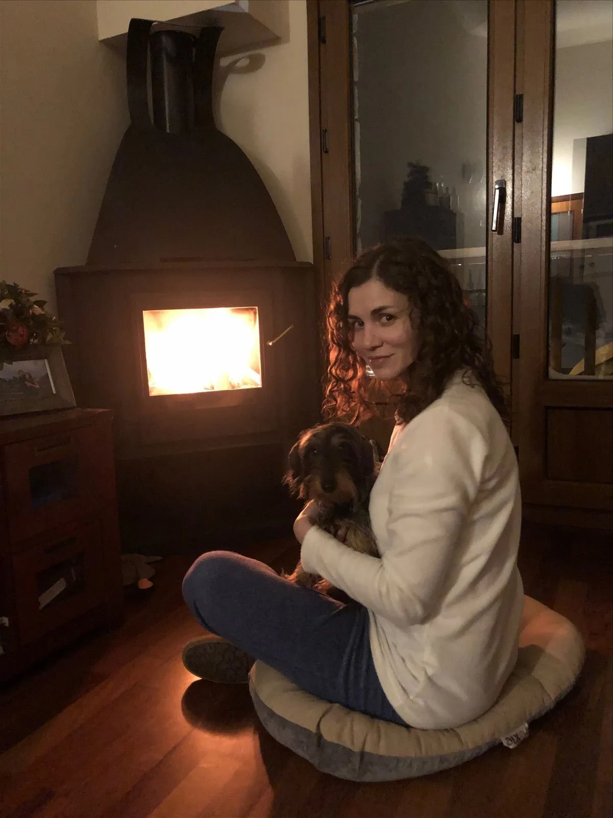 Woman by fireplace in Andorra