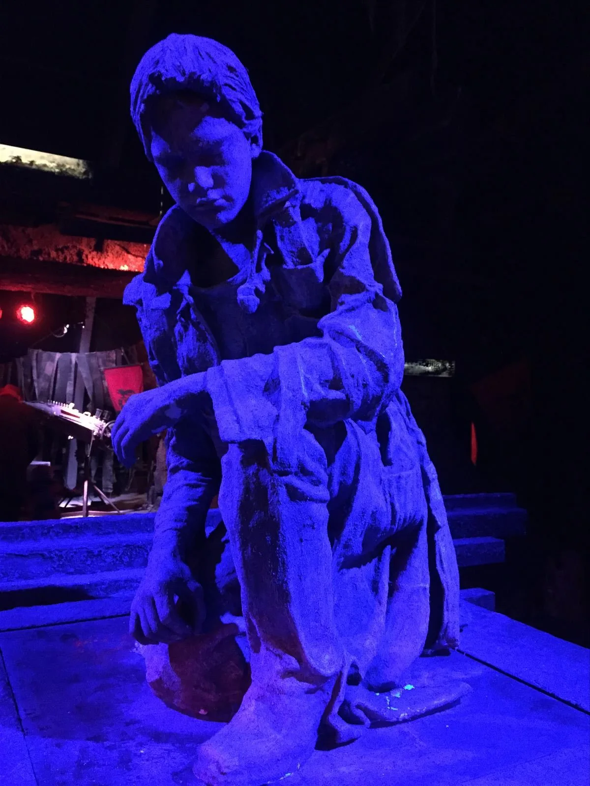 Sculpture in blue lighting on stage