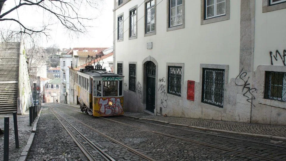 Yellow tram on cobblestone streets of Lisbon