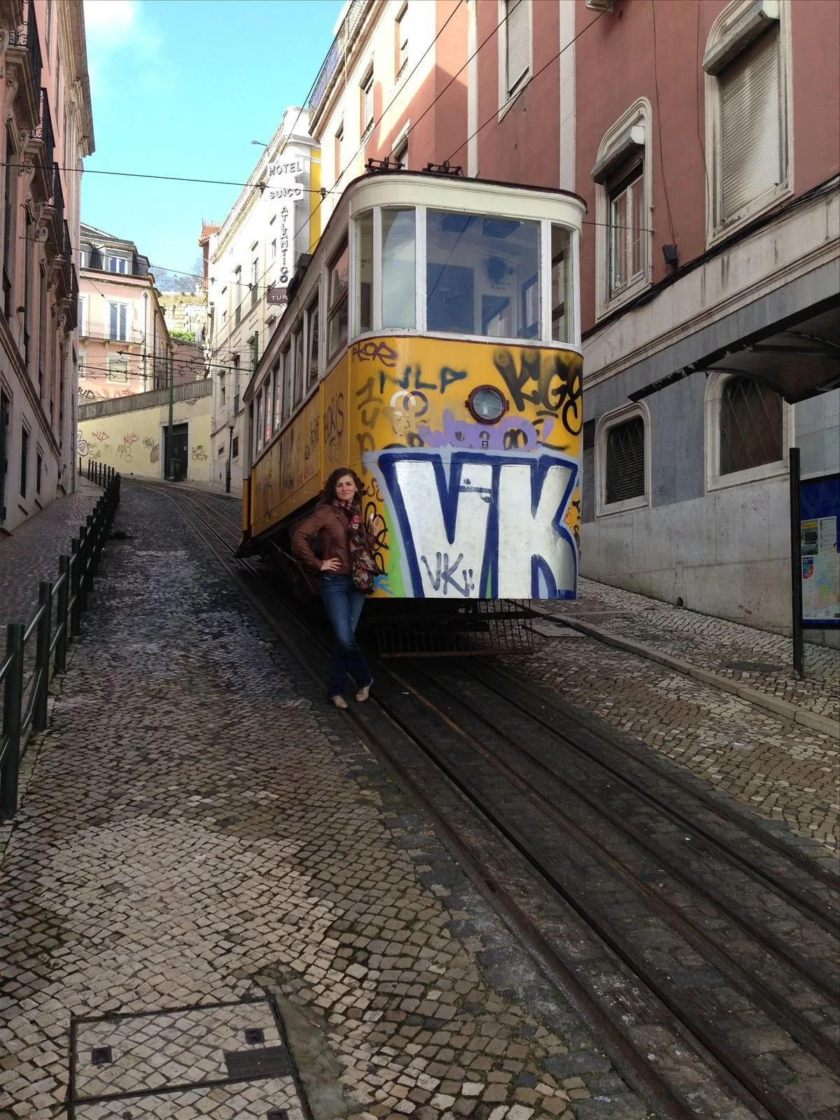 Tram 28 with graffiti on a Lisbon street