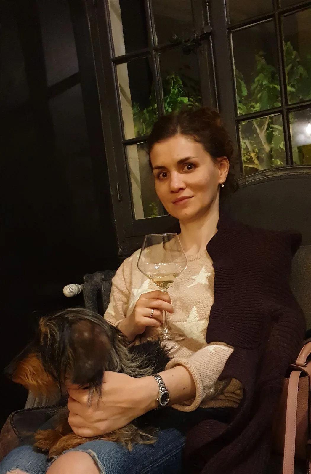 Woman with a glass of wine in chateau restaurant