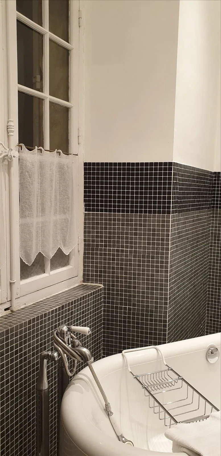 Tulle curtains and tiled wall