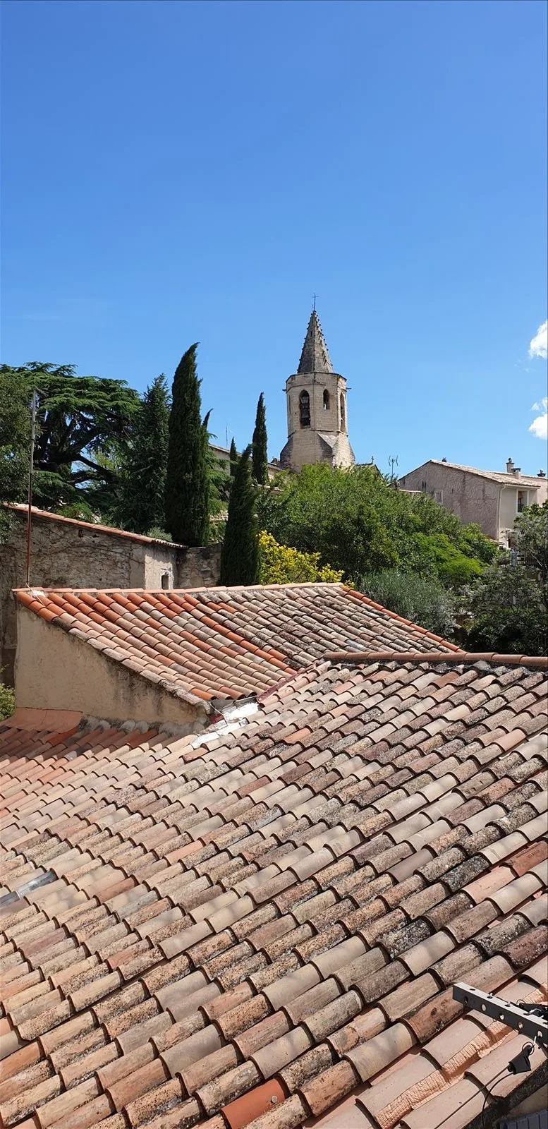 Tiled roofs of Mazan village with tower