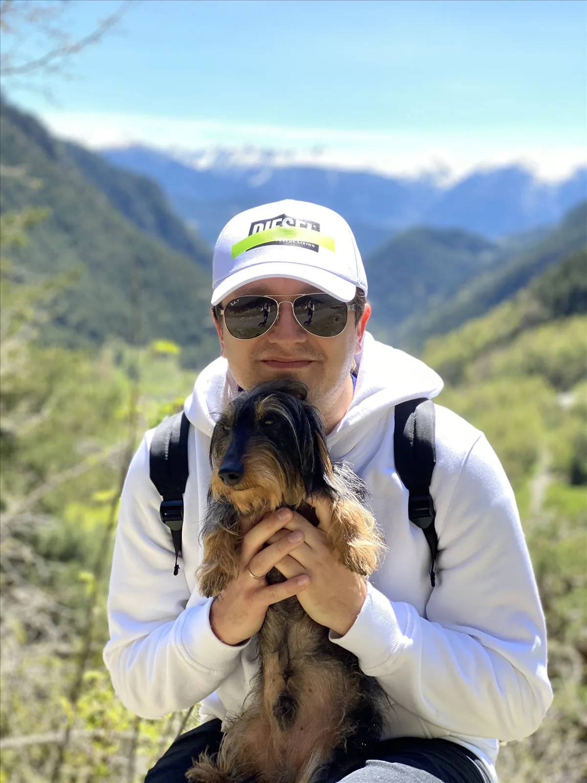 Man in a cap with a dog in Andorra mountains