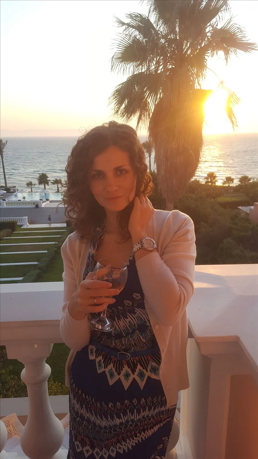 Girl with a glass against the Ionian Sea