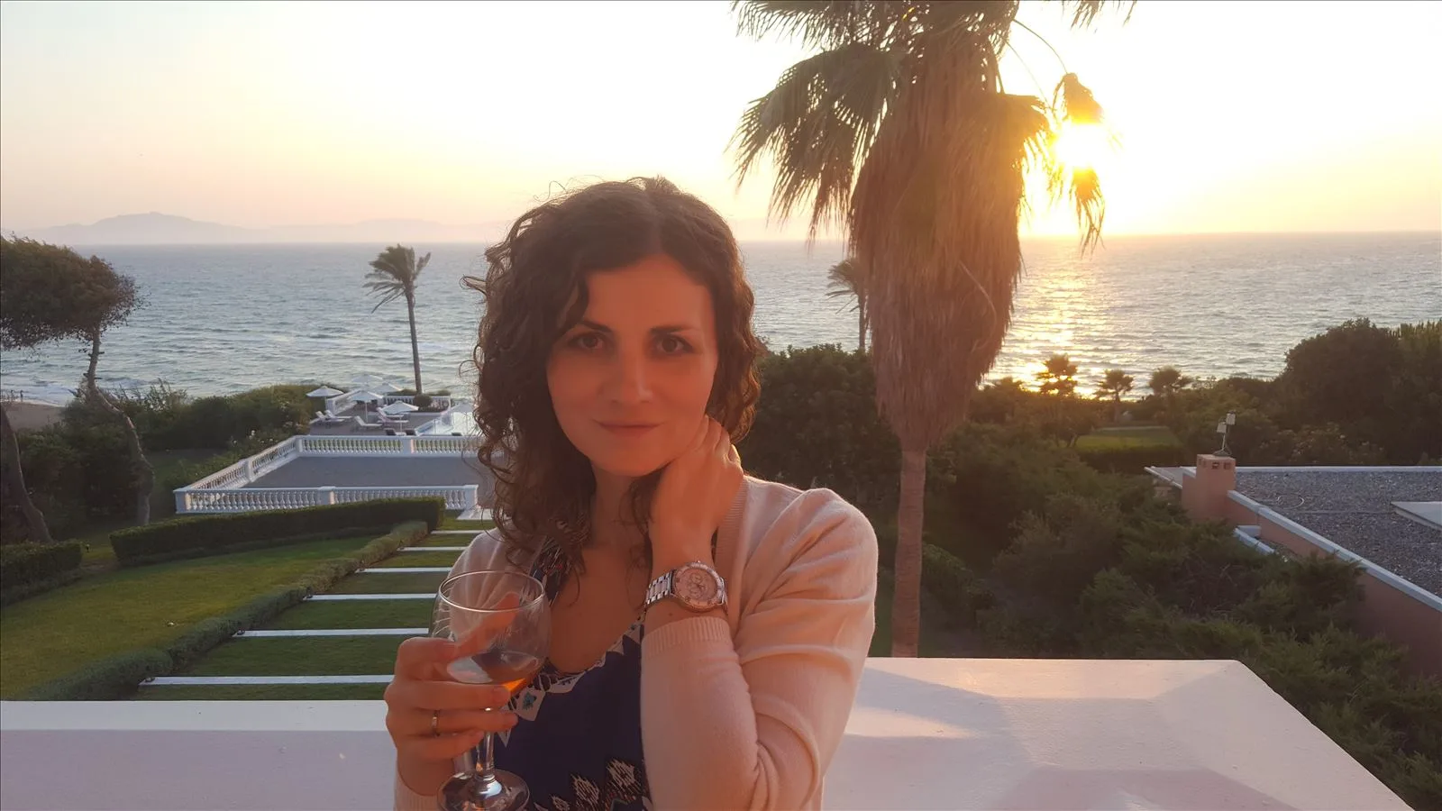 Girl against sunset sea in Greece