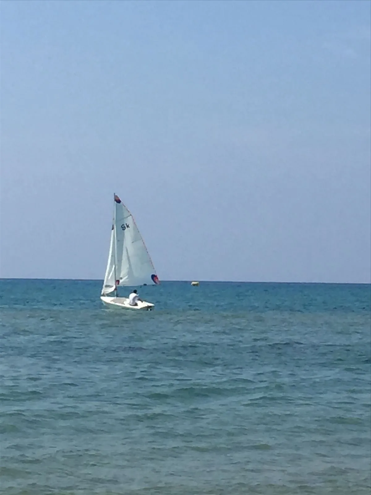 Sailing yacht against the blue sea