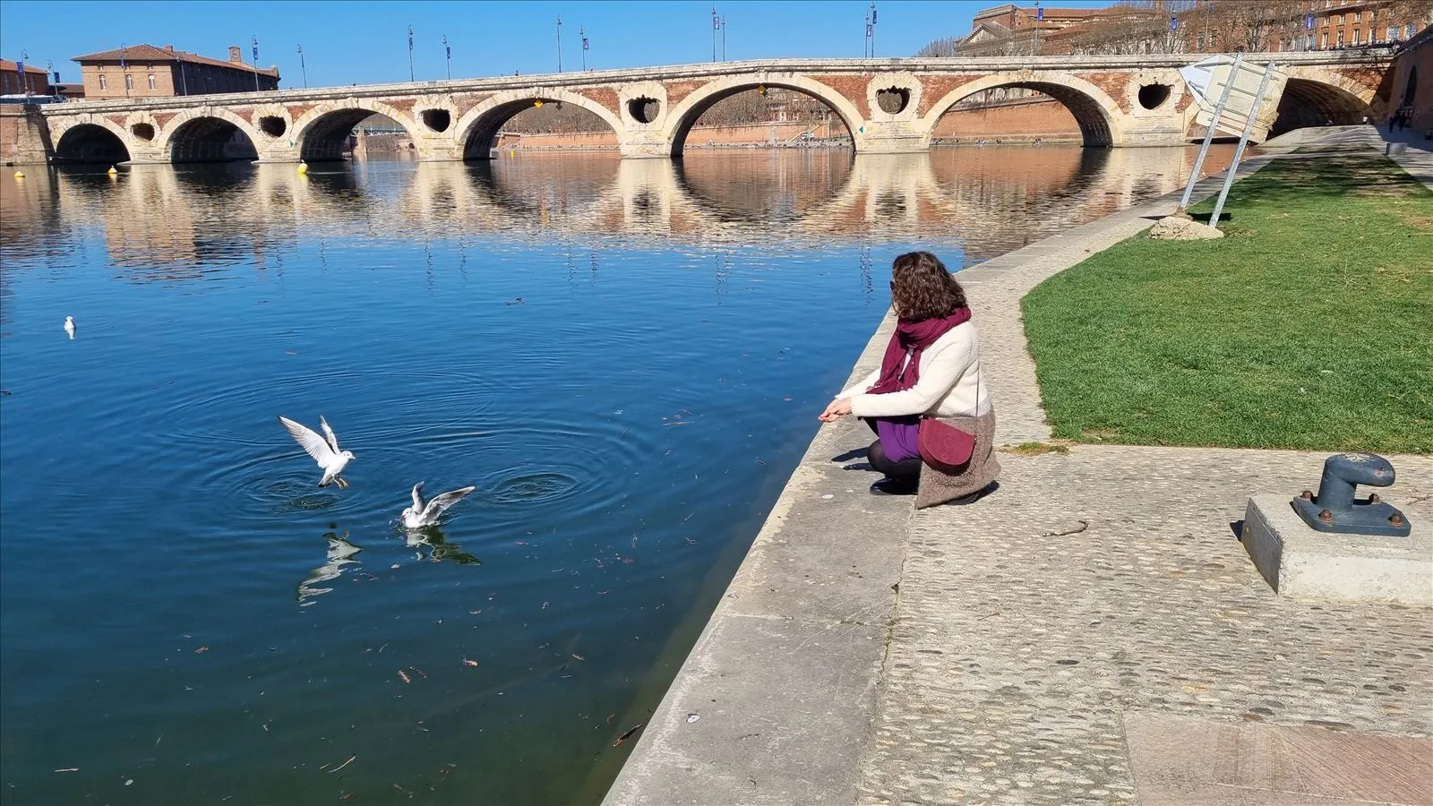 Woman sitting by the Garonne River