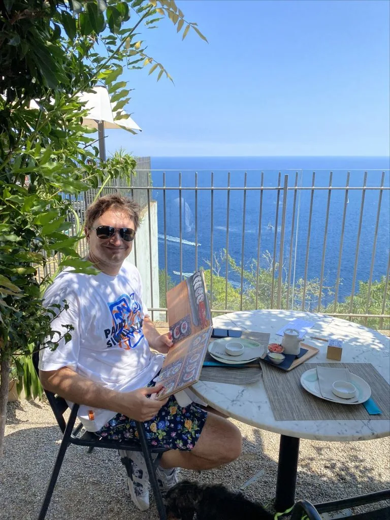 Man with cocktail on seaside terrace
