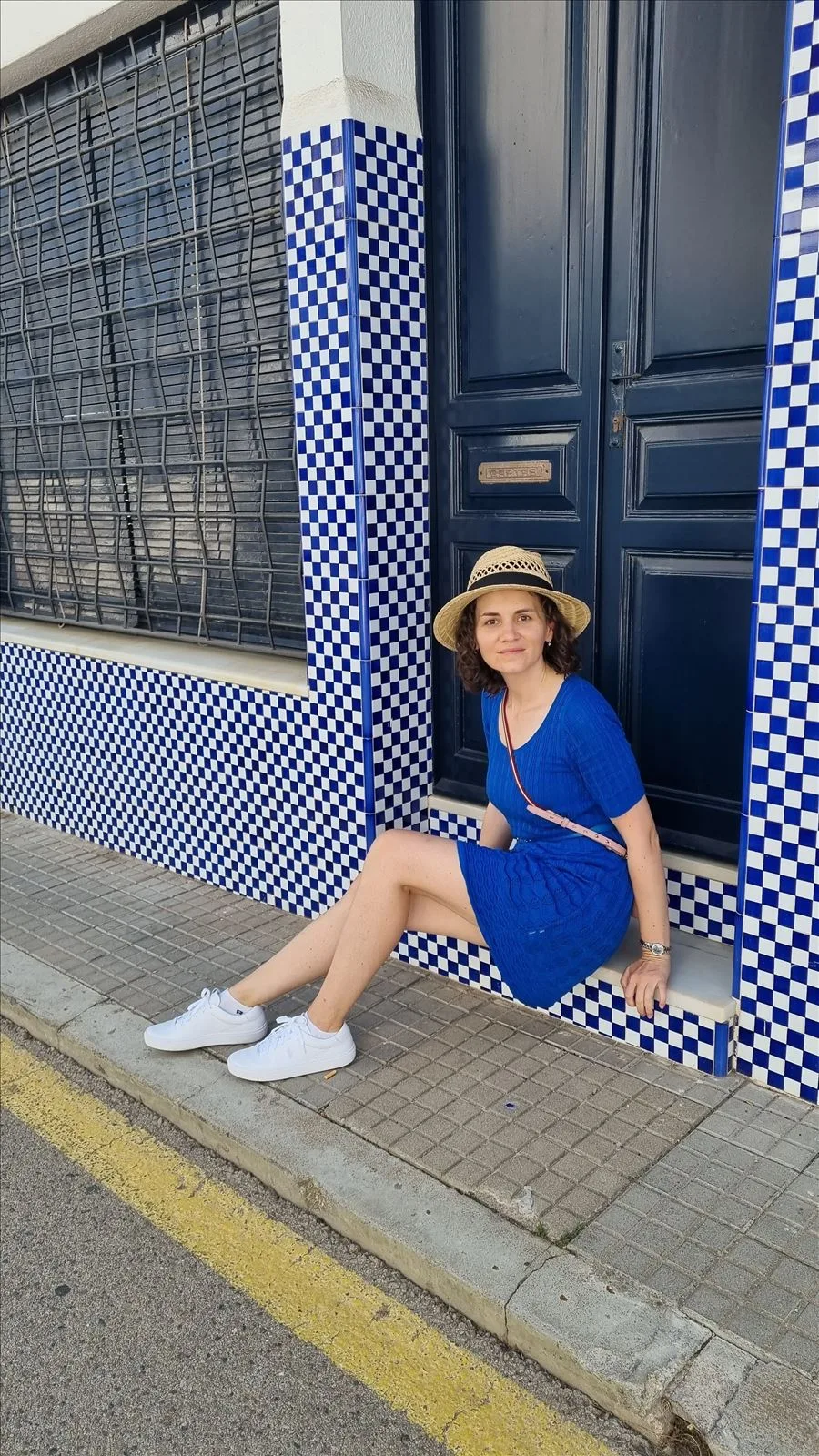 Girl against blue tiles in Begur