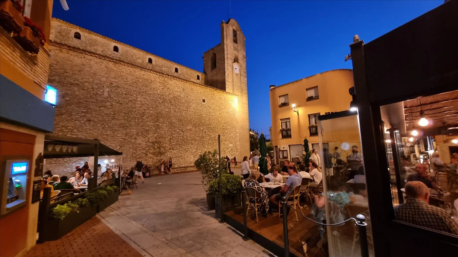 Street café under trees in Begur in the evening