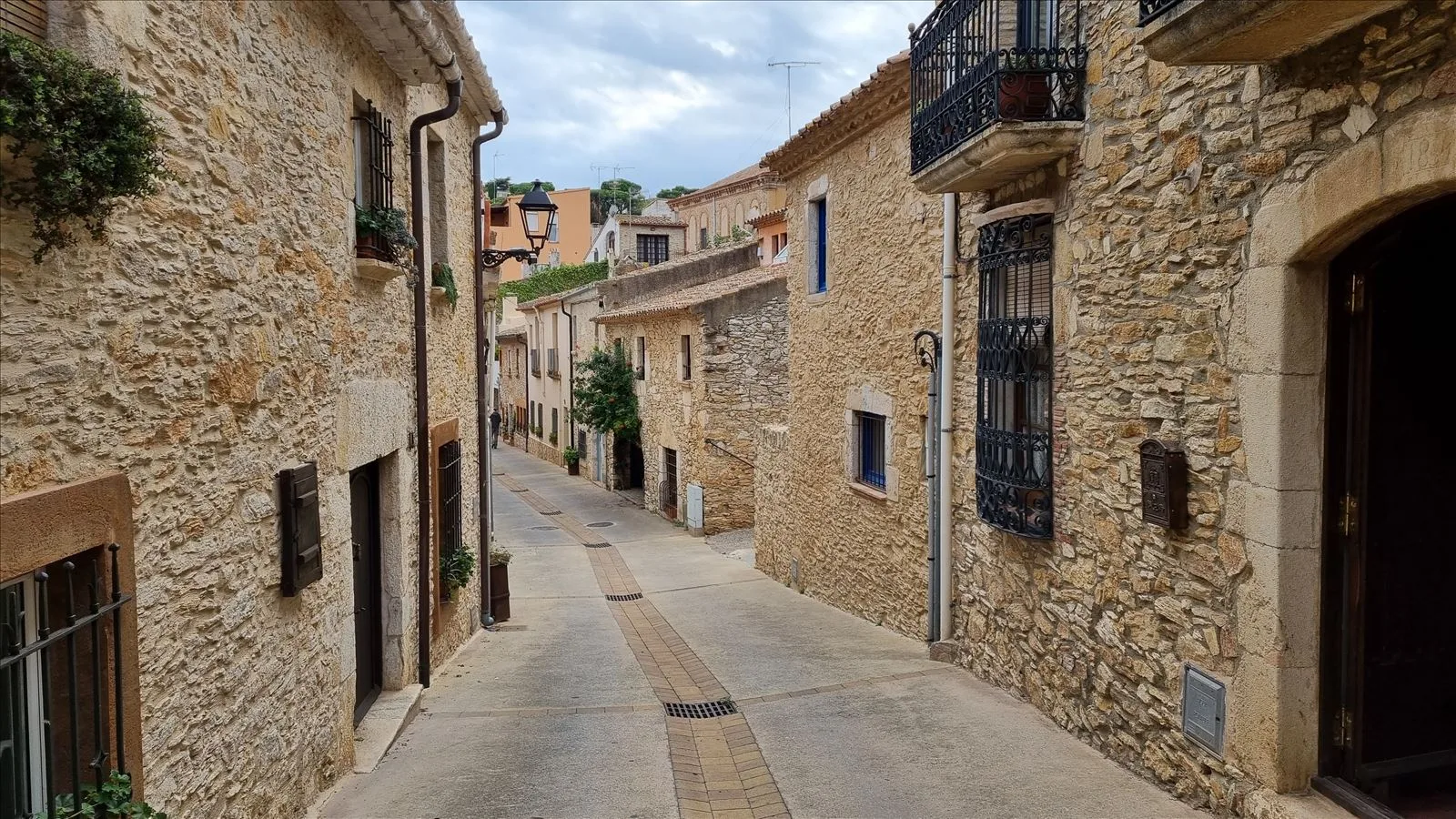 Stone street in Begur with arches