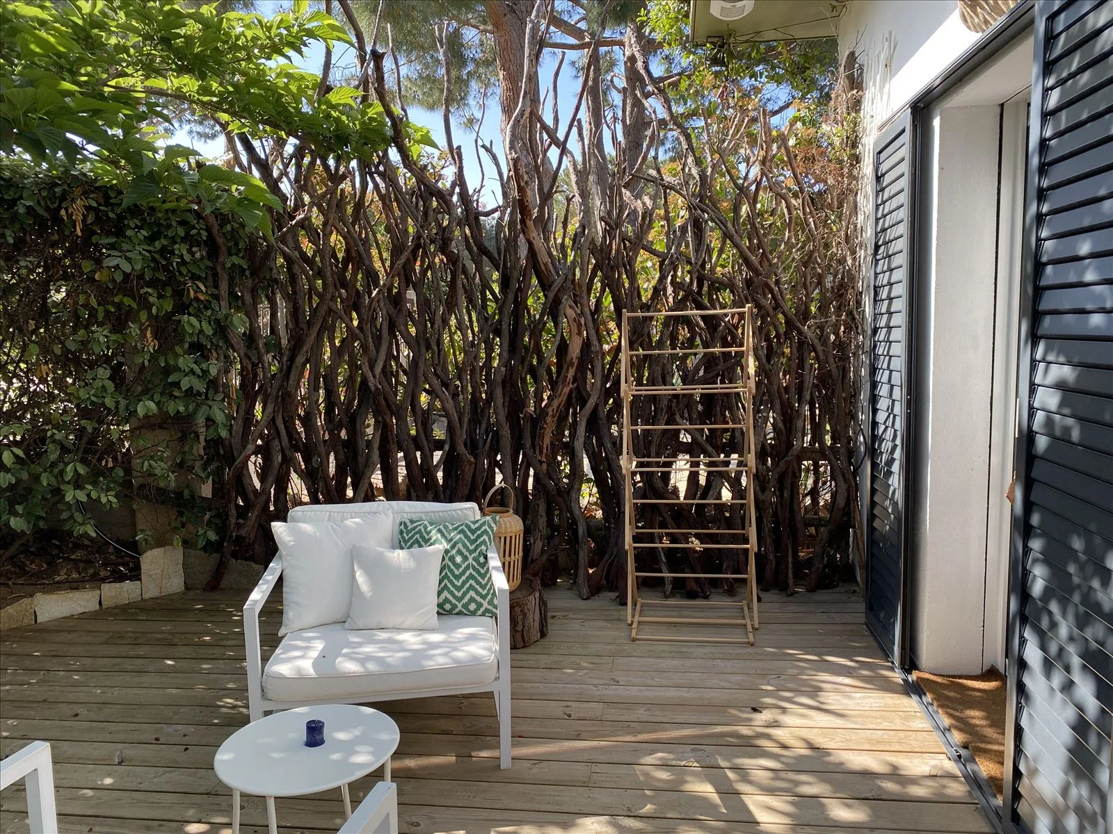 Wooden terrace with furniture by the garden