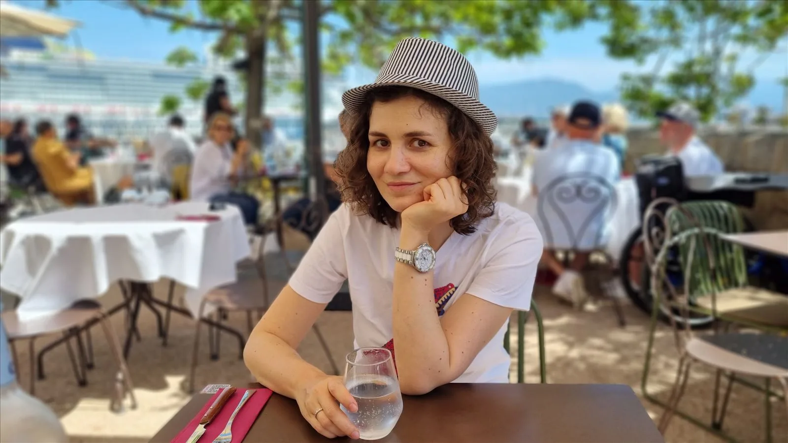 Girl at a table on a summer terrace