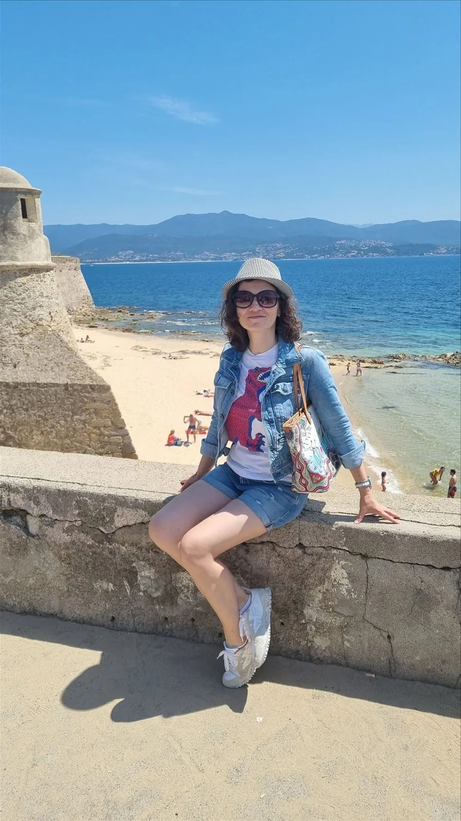 Girl sitting on the waterfront in Ajaccio