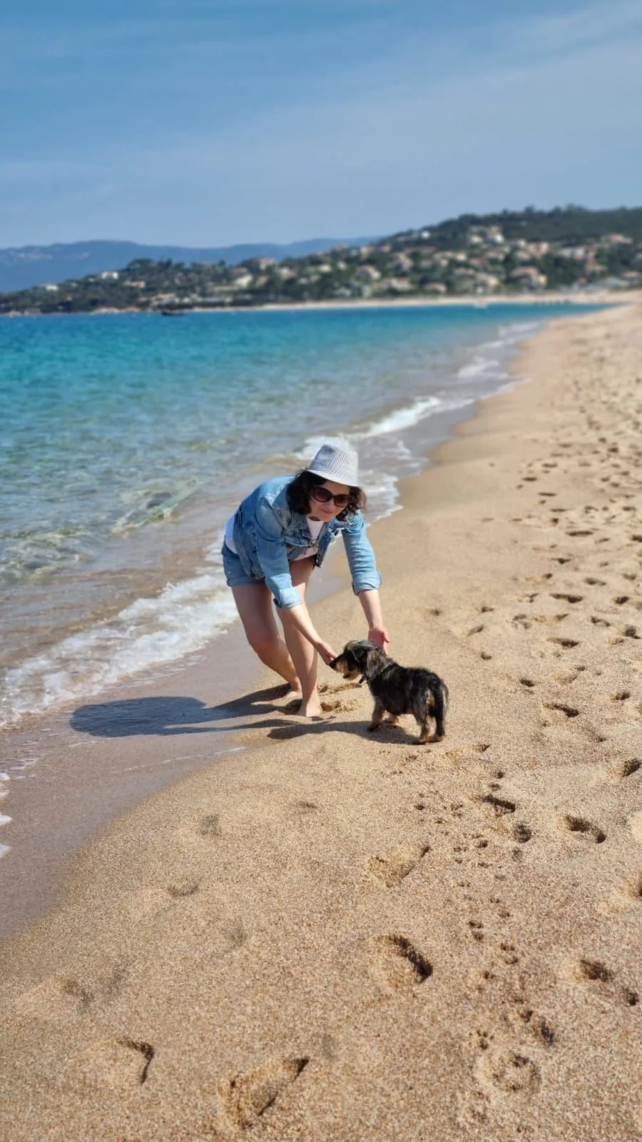 Girl with a dog by the shoreline