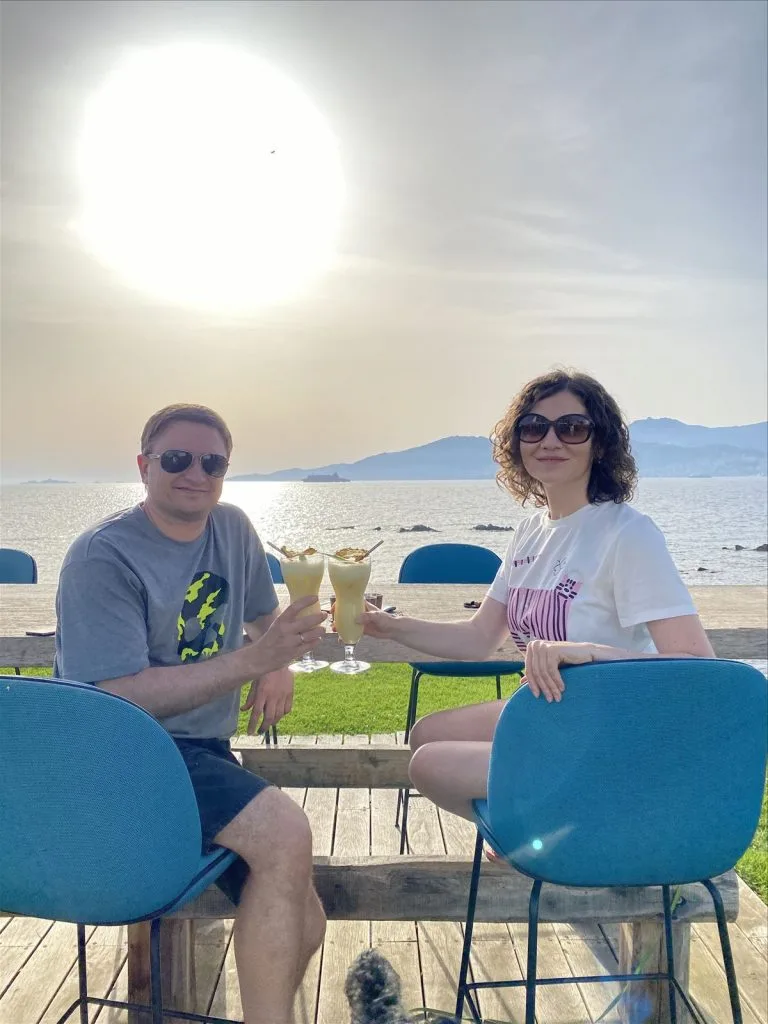 Couple with glasses at sunset in Corsica