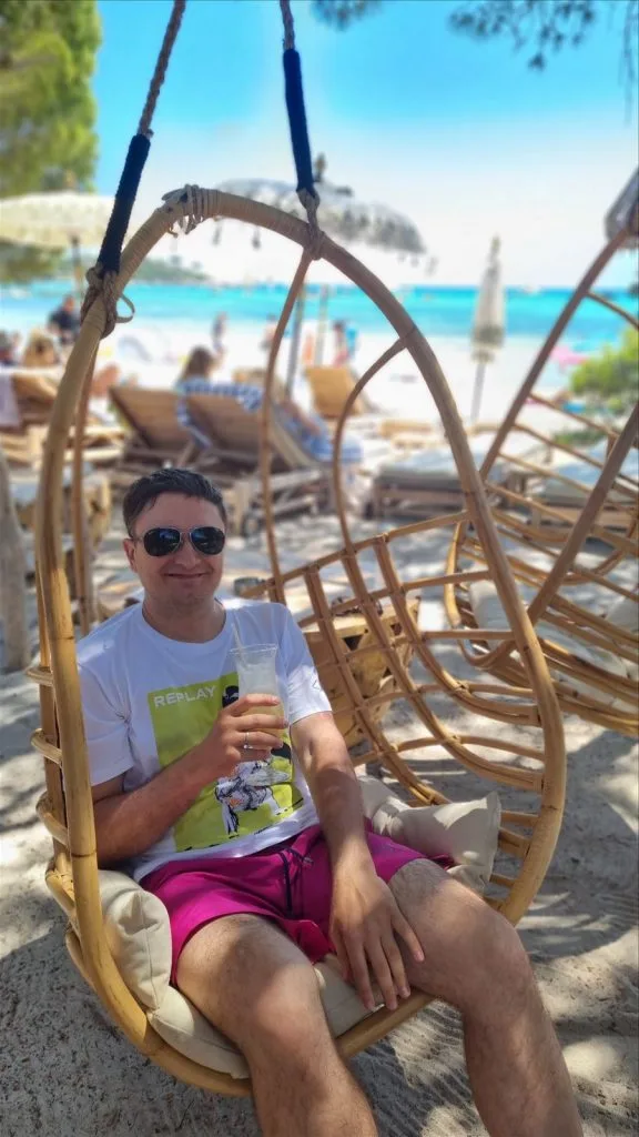 Man in a wicker chair on the beach