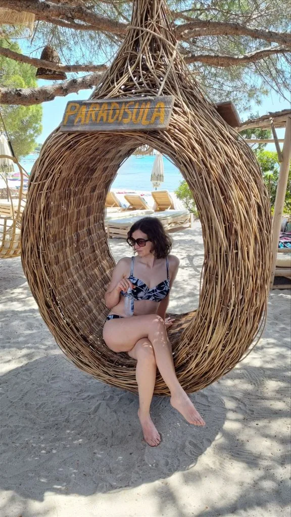 Girl in a wicker chair by the sea