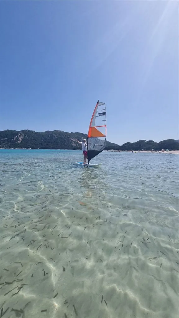 Windsurfer in turquoise bay of Corsica