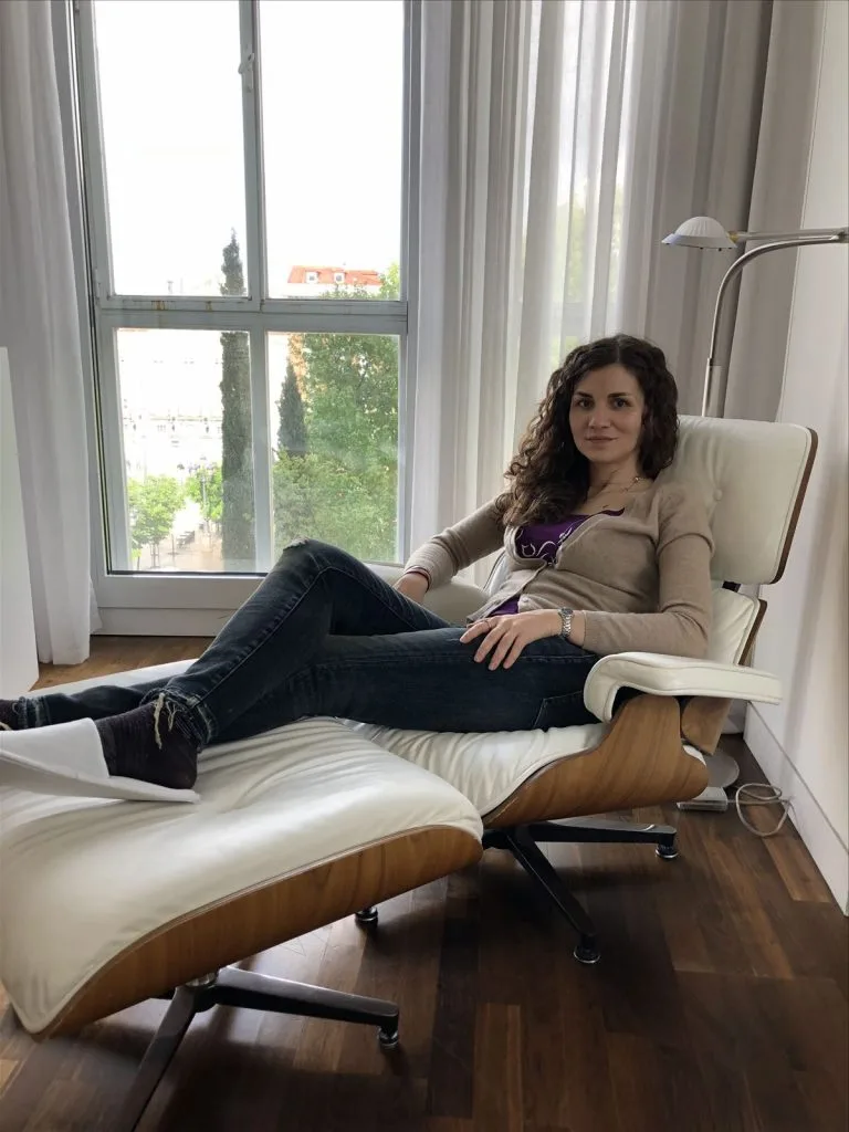 Girl in a chair with a view of Madrid from the window