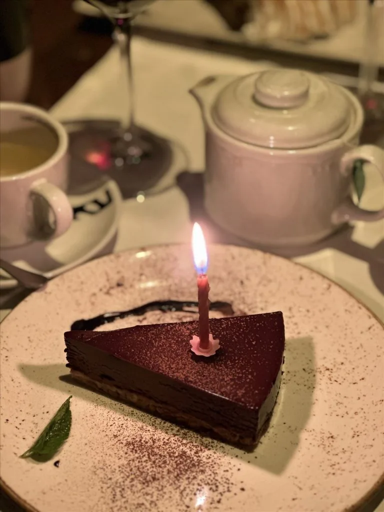 Chocolate cake with candle in restaurant