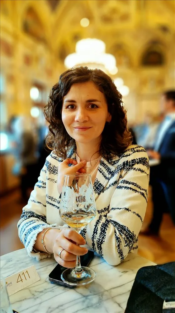 Woman with drink in Vienna Opera foyer