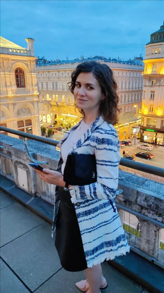 Girl with a phone on a balcony in Vienna